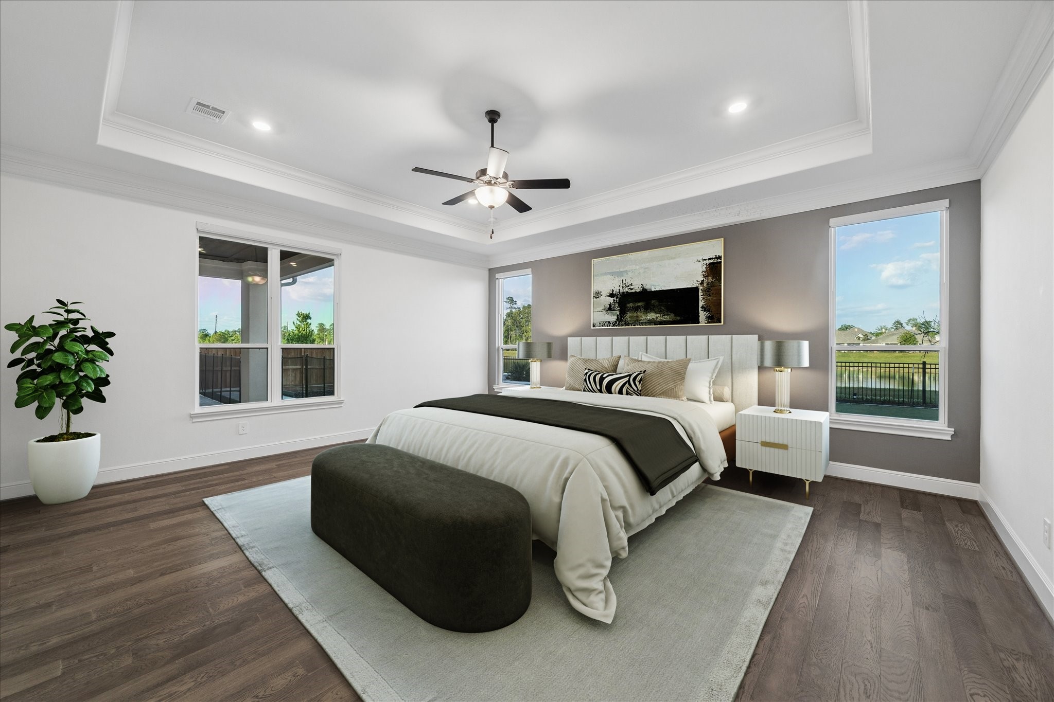 28015 Royal Swan Lane Spring, TX 77386 - Photo 14 of 25 Spacious primary suite featuring a tray ceiling, rich wood flooring, and abundant natural light. Serene views and elegant finishes create a relaxing retreat. *Virtually Staged