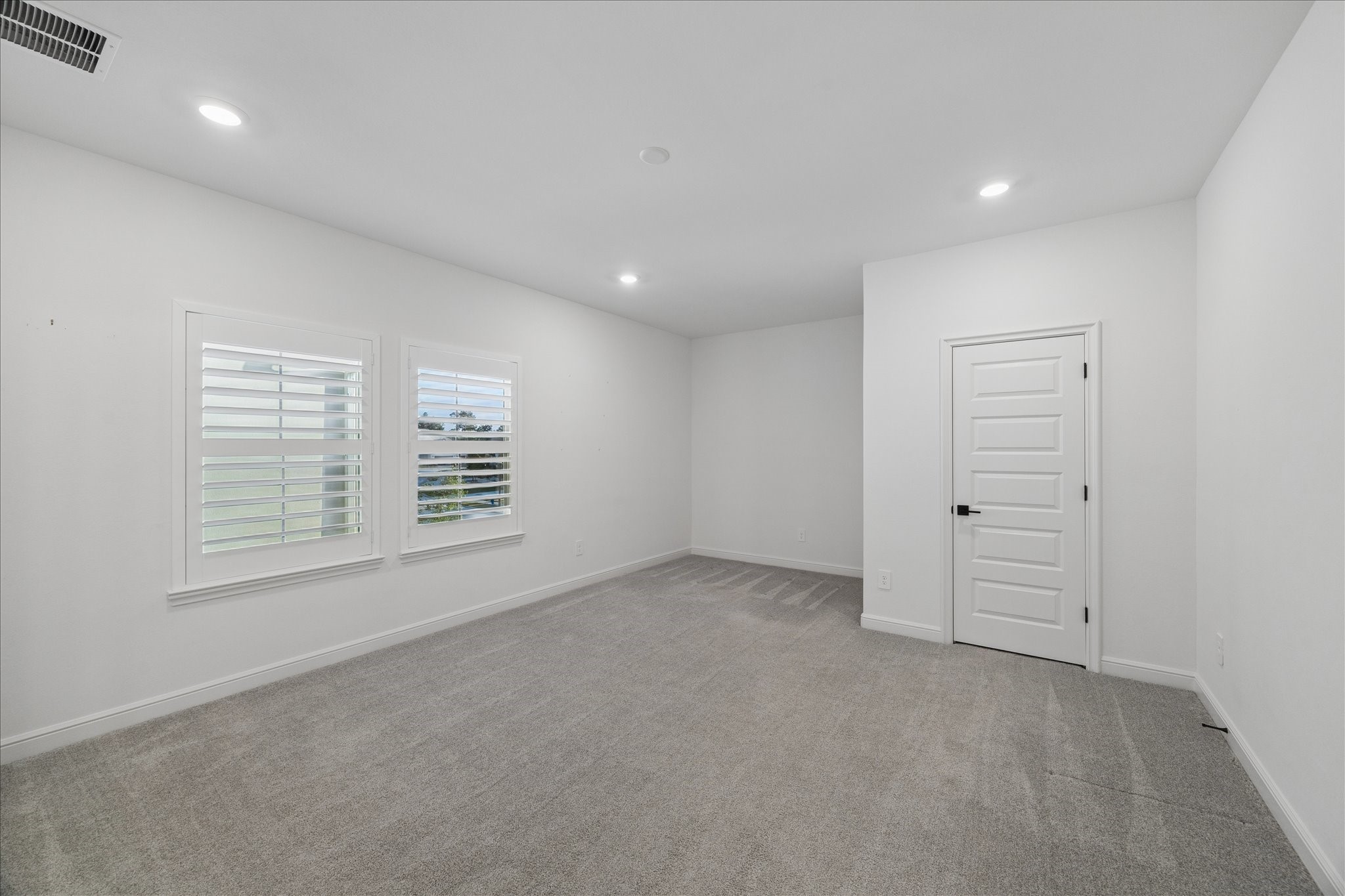 28015 Royal Swan Lane Spring, TX 77386 - Photo 17 of 25 Spacious guest bedroom featuring soft natural light, plush carpeting, and a comfortable layout ideal for visitors or additional living space.