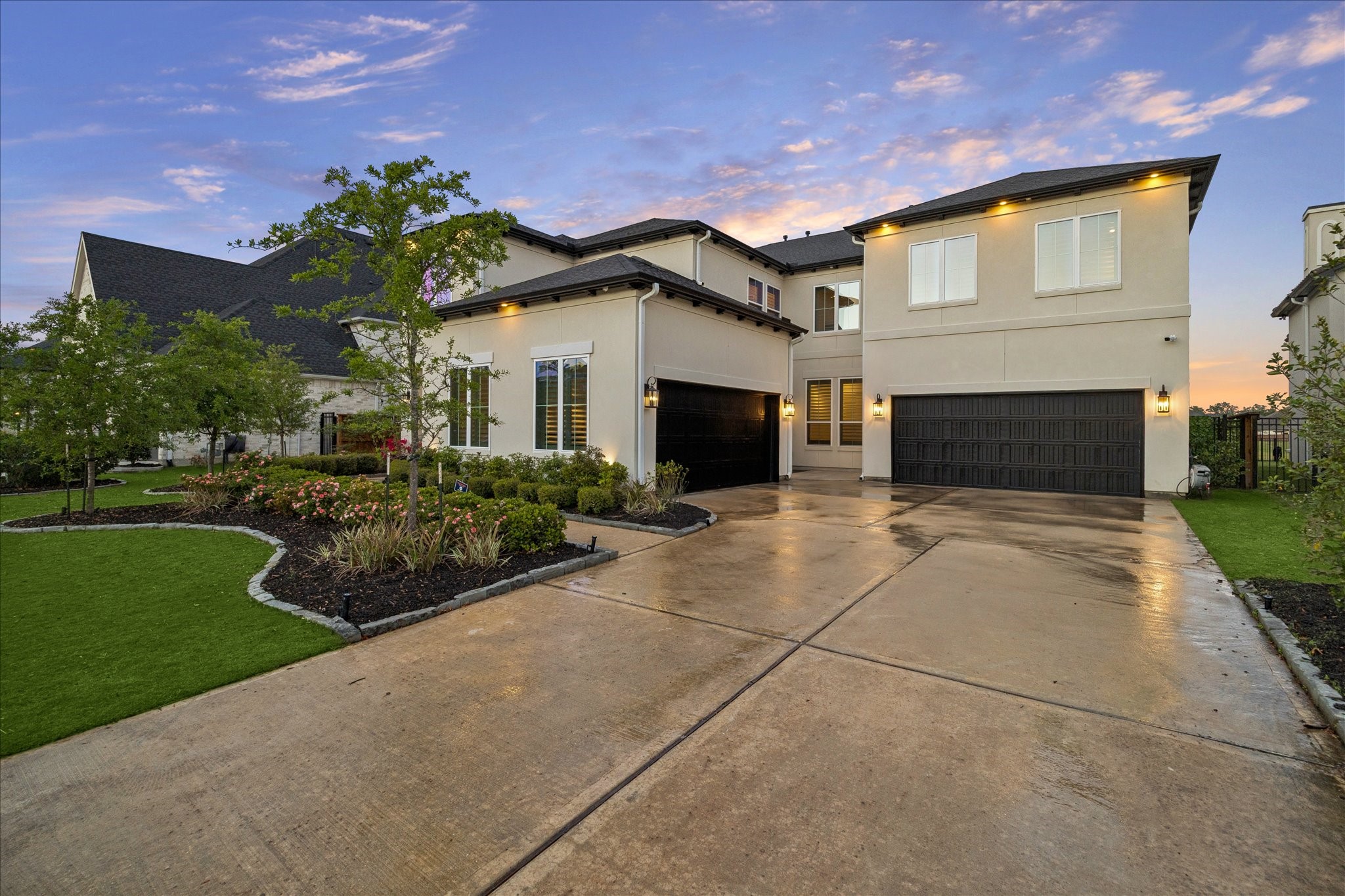 28015 Royal Swan Lane Spring, TX 77386 - Photo 25 of 25 Spacious driveway leading to multiple garage bays, offering ample parking and storage. The beautifully maintained exterior and landscaping create a polished and welcoming approach to the home.