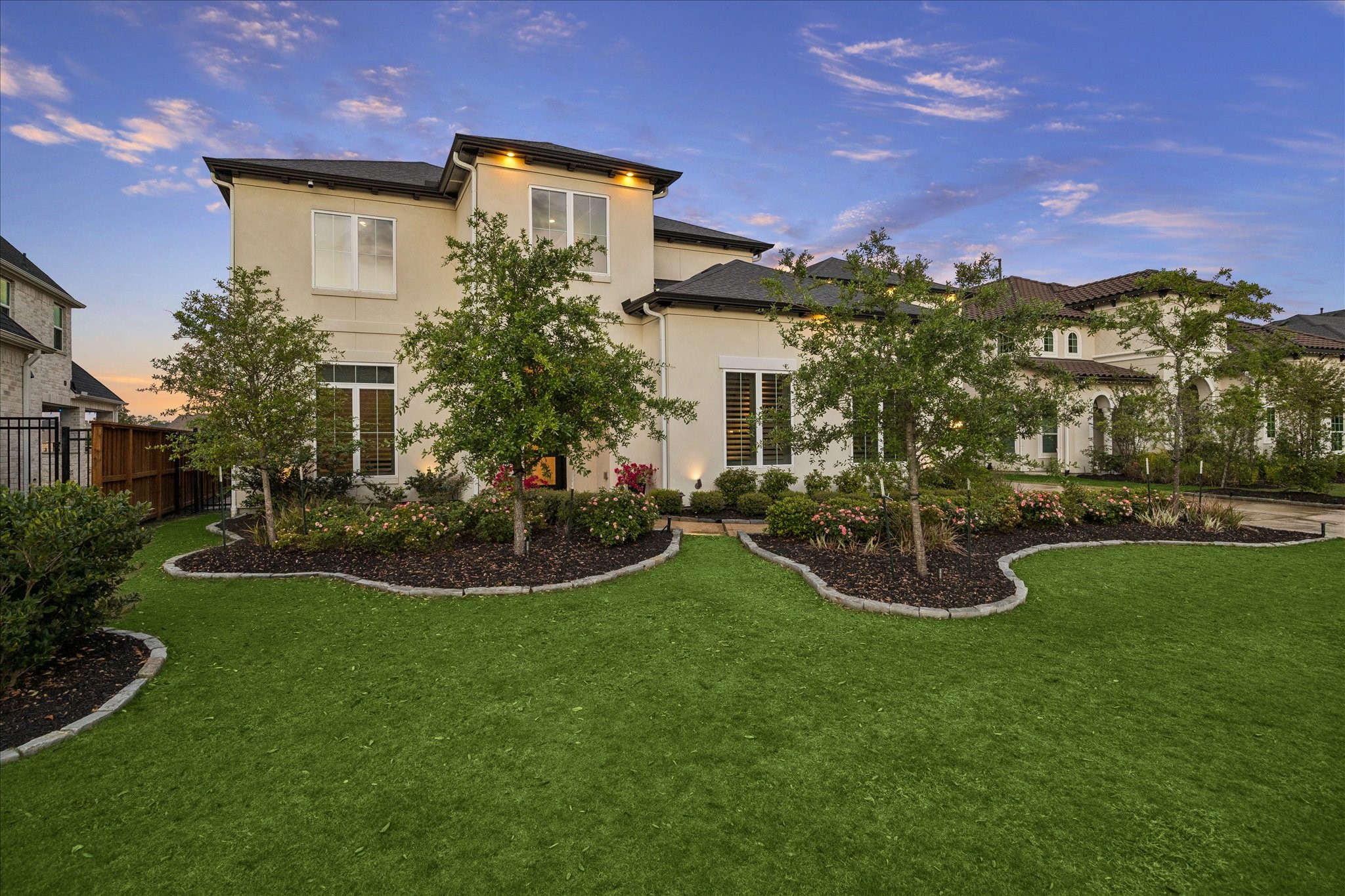 28015 Royal Swan Lane Spring, TX 77386 - Photo 3 of 25 Beautifully landscaped front yard with a manicured lawn, mature trees, and thoughtfully designed garden beds, creating a warm and inviting first impression with exceptional curb appeal.