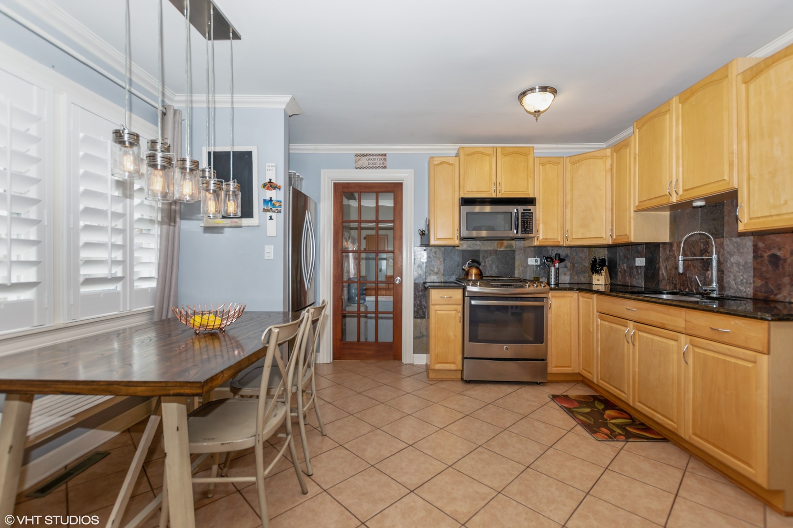 10906 Parkside Avenue Chicago Ridge, IL 60415 - Photo 3 of 15 a kitchen with stainless steel appliances kitchen island granite countertop a stove a sink a microwave and a refrigerator