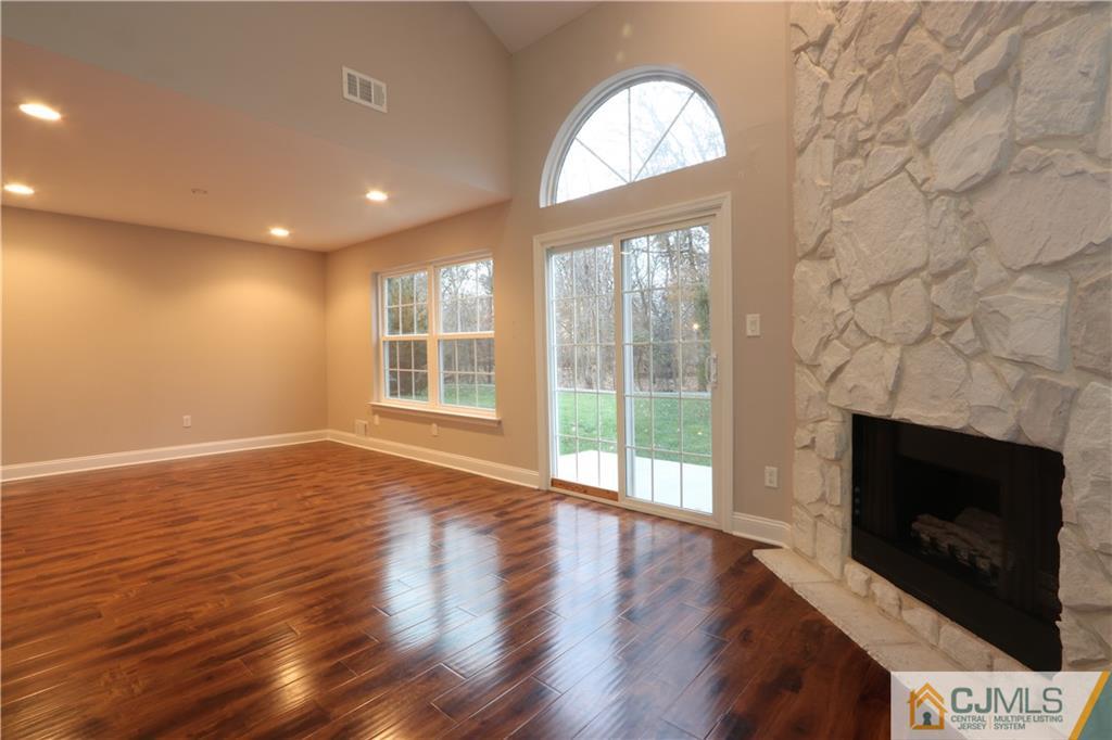185 Nebula Road Piscataway, NJ 08854 - Photo 2 of 20 a view of empty room with wooden floor and fireplace