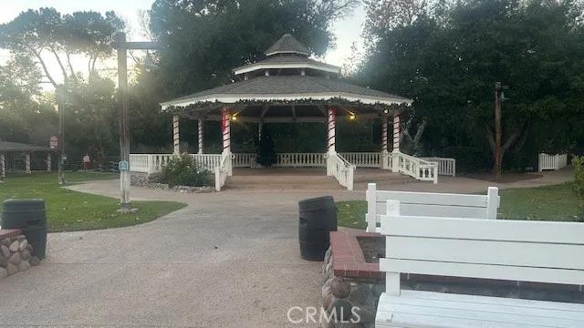 a outdoor space with lots of trees and couches