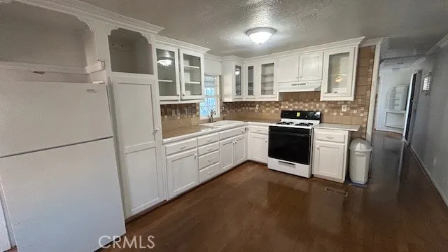 a bathroom with a sink shower and mirror