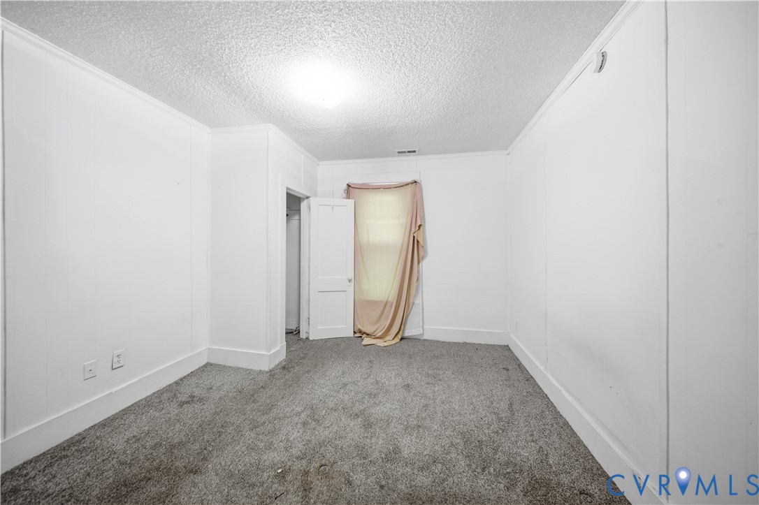 27 Bacon Street Hampton, VA 23669 - Photo 5 of 18 Unfurnished bedroom with carpet floors, a textured