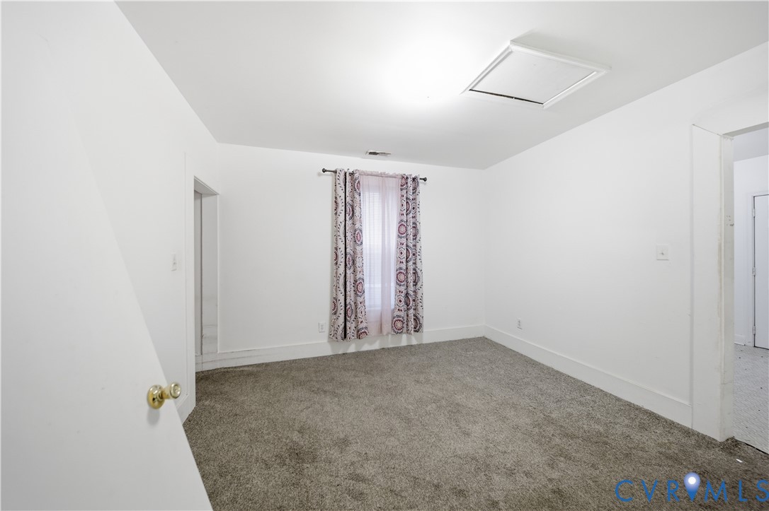 27 Bacon Street Hampton, VA 23669 - Photo 6 of 18 Empty room with attic access and carpet floors