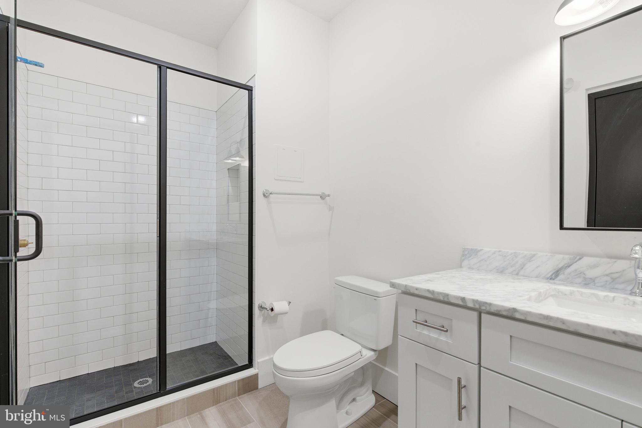 1801 North Howard Street, Unit C04 Philadelphia, PA 19122 - Photo 14 of 22 a bathroom with a granite countertop sink toilet and shower