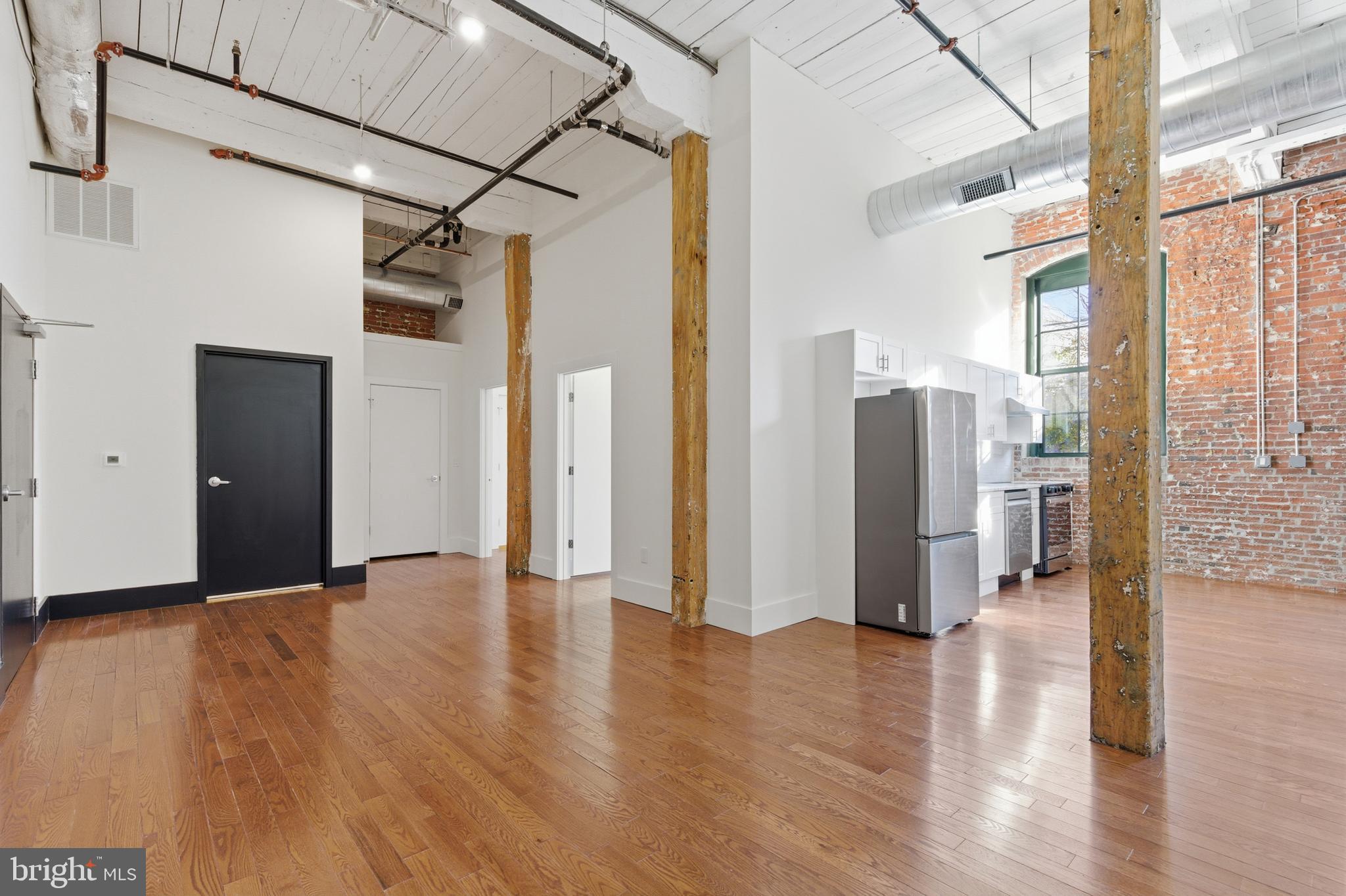 1801 North Howard Street, Unit C04 Philadelphia, PA 19122 - Photo 6 of 22 a view of a big room with wooden floor and windows