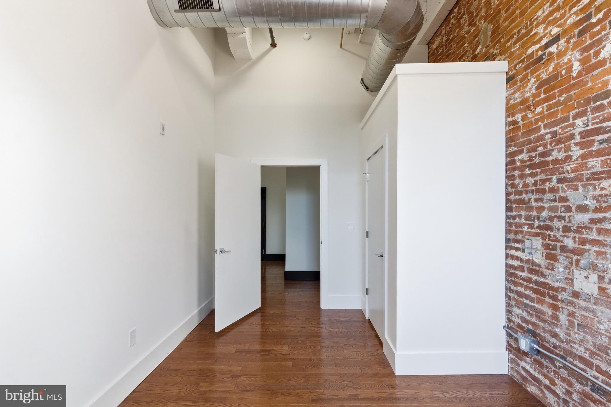 1801 North Howard Street, Unit C04 Philadelphia, PA 19122 - Photo 9 of 22 a view of a hallway with wooden cabinets