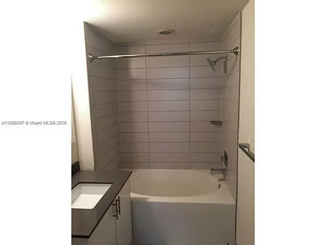 a bathroom with a bathtub and sink