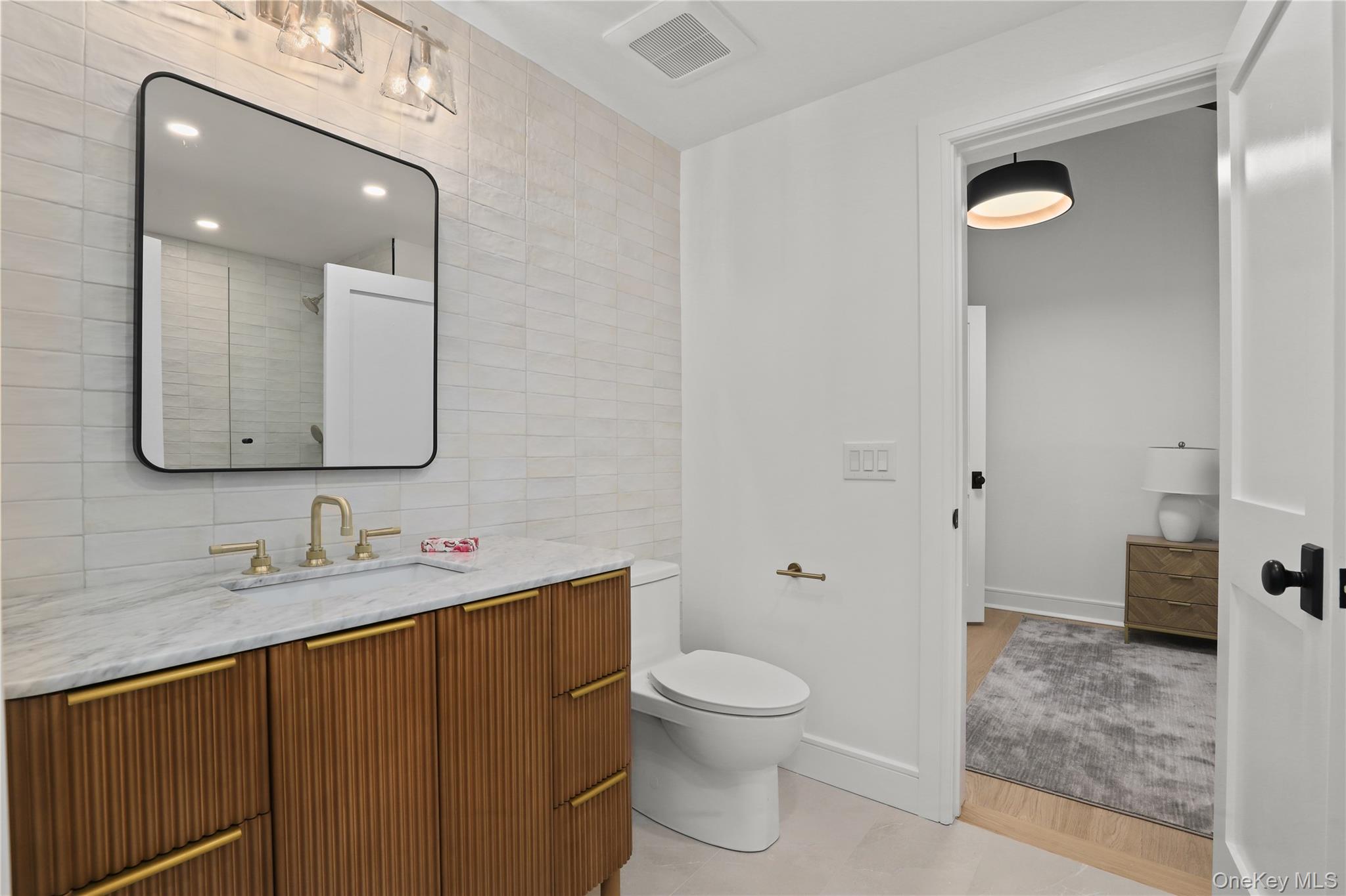 39 Old Snake Hill Road Pound Ridge, NY 10576 - Photo 21 of 37 a bathroom with a toilet sink and mirror