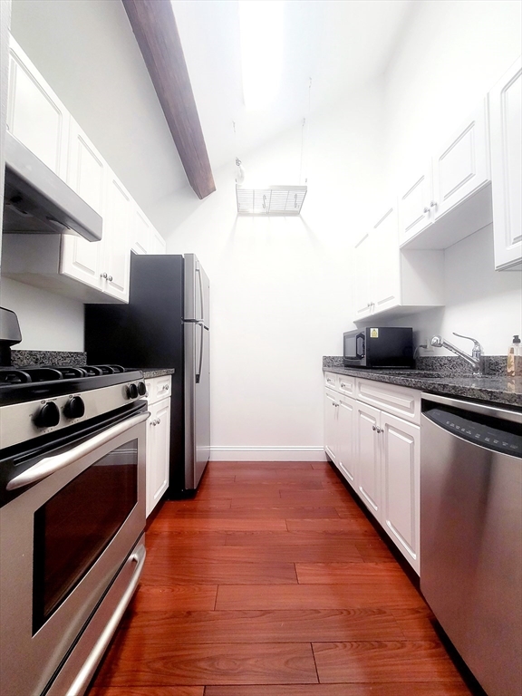42 8th Street, Unit 2515 Boston, MA 02129 - Photo 13 of 29 a kitchen with a stove and a microwave