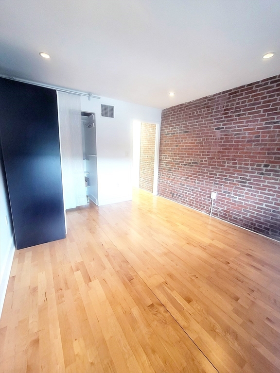 42 8th Street, Unit 2515 Boston, MA 02129 - Photo 15 of 29 a view of an empty room with wooden floor