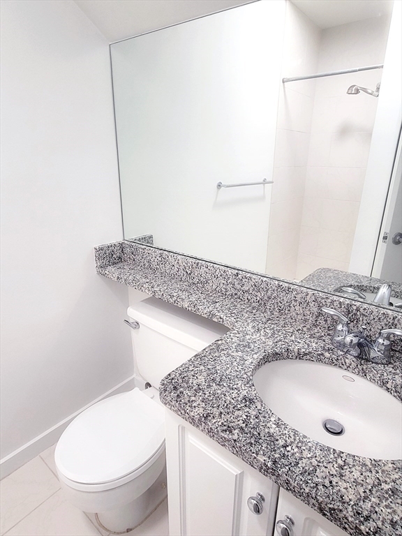 42 8th Street, Unit 2515 Boston, MA 02129 - Photo 22 of 29 a bathroom with a granite countertop sink and a toilet