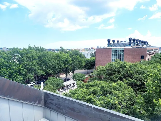 a view of a balcony with wooden fence