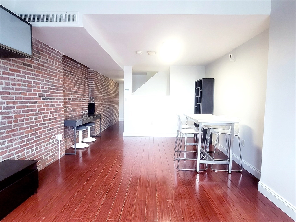 42 8th Street, Unit 2515 Boston, MA 02129 - Photo 5 of 29 a view of a livingroom with furniture and wooden floor