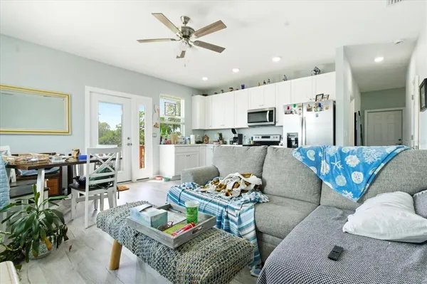a kitchen with stainless steel appliances white cabinets and a stove top oven