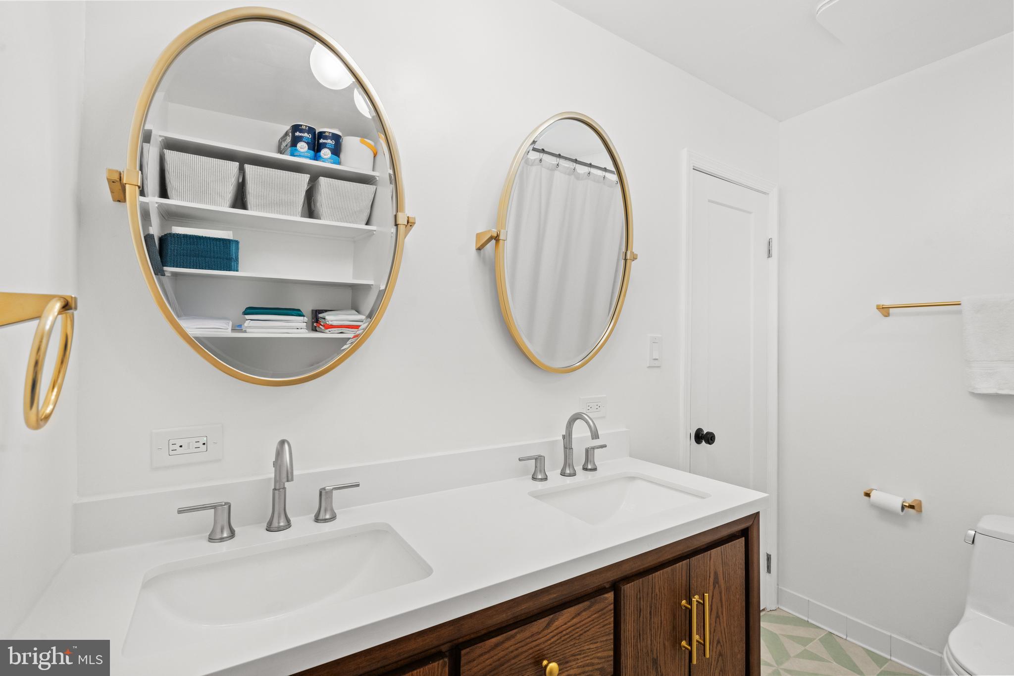 3527 Hamlet Place Chevy Chase, MD 20815 - Photo 13 of 19 a bathroom with a sink and a mirror