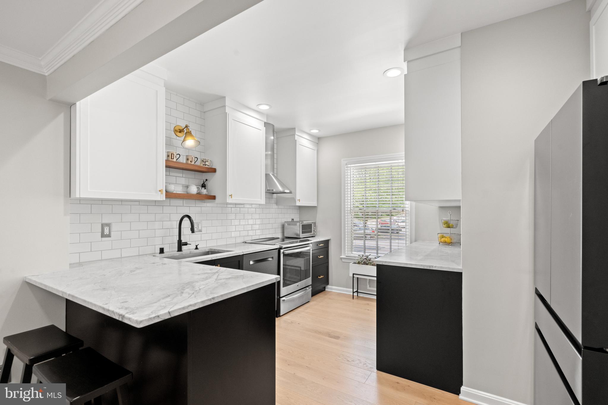 3527 Hamlet Place Chevy Chase, MD 20815 - Photo 5 of 19 a kitchen with a sink a stove a refrigerator and cabinets