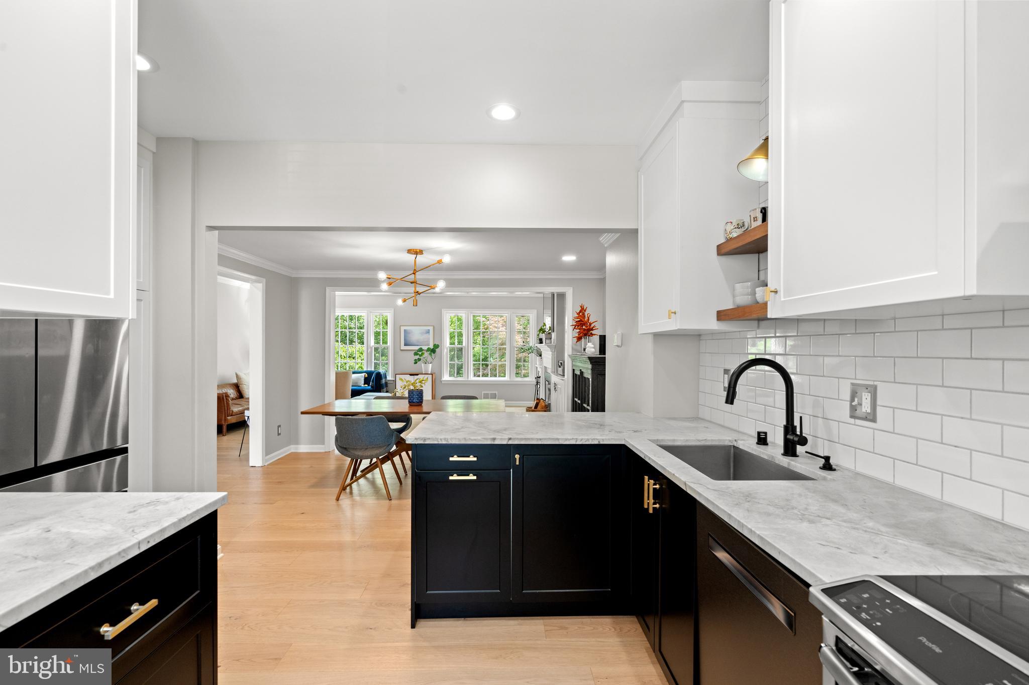 3527 Hamlet Place Chevy Chase, MD 20815 - Photo 7 of 19 a large kitchen with granite countertop a sink and cabinets