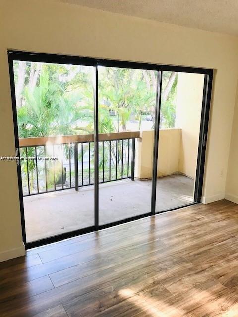 6236 Southwest 136th Court, Unit B105 Miami, FL 33183 - Photo 11 of 22 a view of an empty room with wooden floor and a window