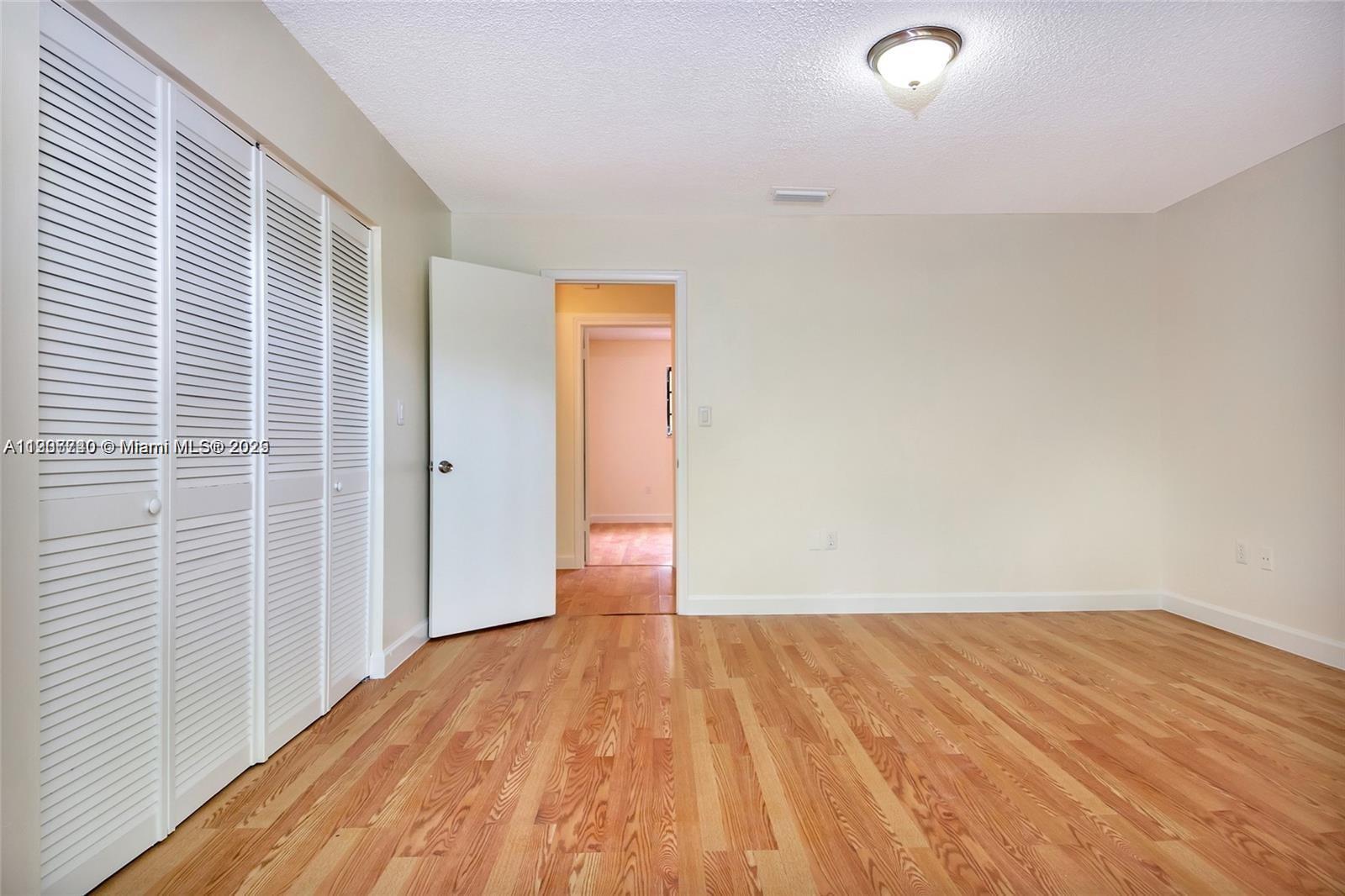 6236 Southwest 136th Court, Unit B105 Miami, FL 33183 - Photo 20 of 22 a view of a room with wooden floor and bathroom