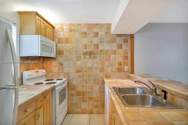 a bathroom with a sink a stove shower and a mirror