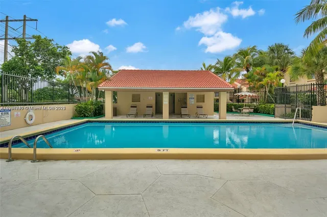 a front view of a house with a garden and tree