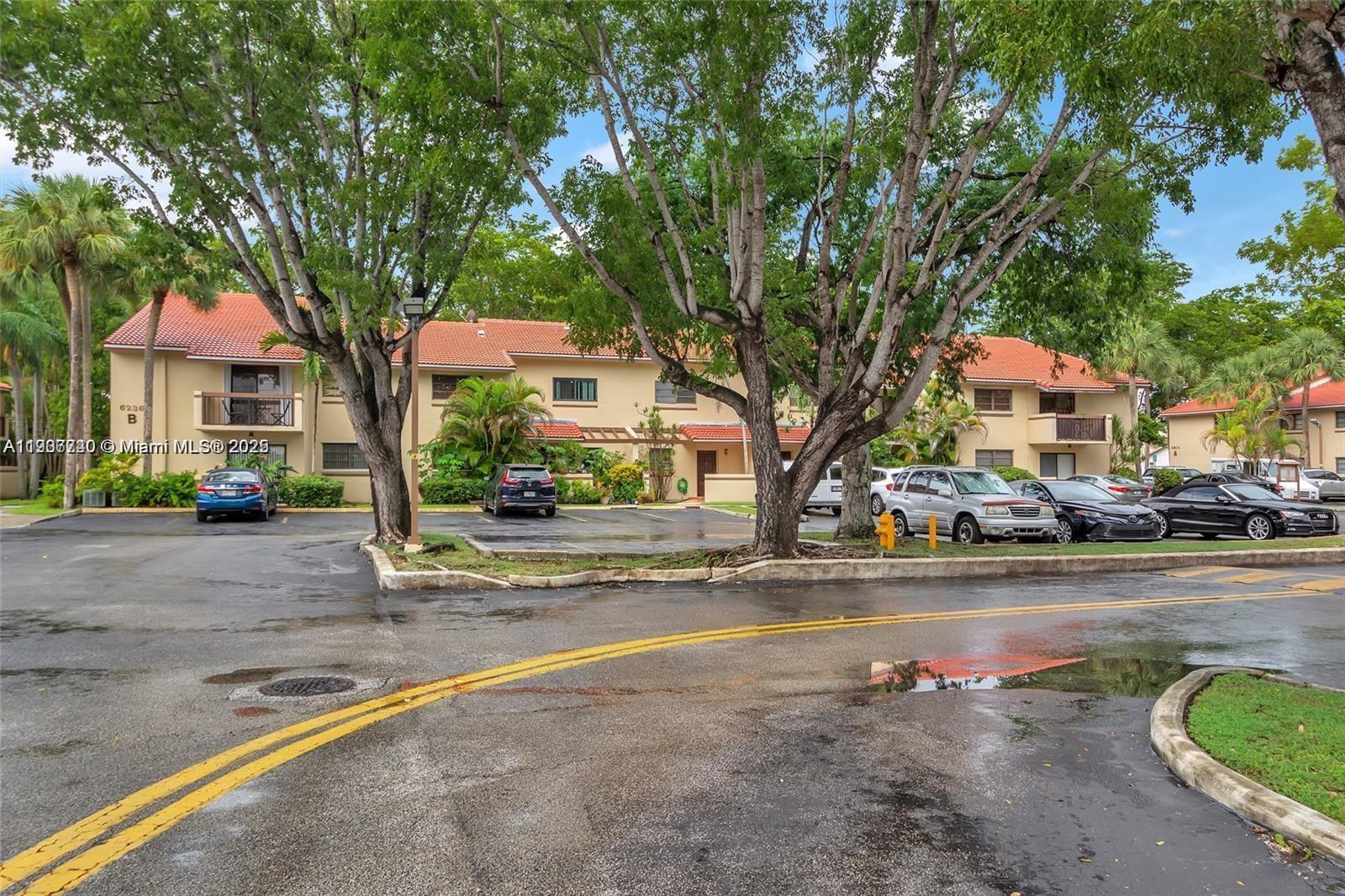 6236 Southwest 136th Court, Unit B105 Miami, FL 33183 - Photo 22 of 22 a front view of a house with a garden and tree