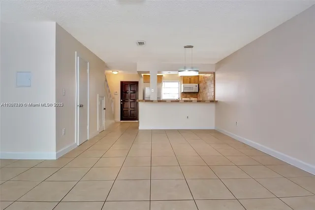 a view of a kitchen with granite countertop cabinets and white appliances