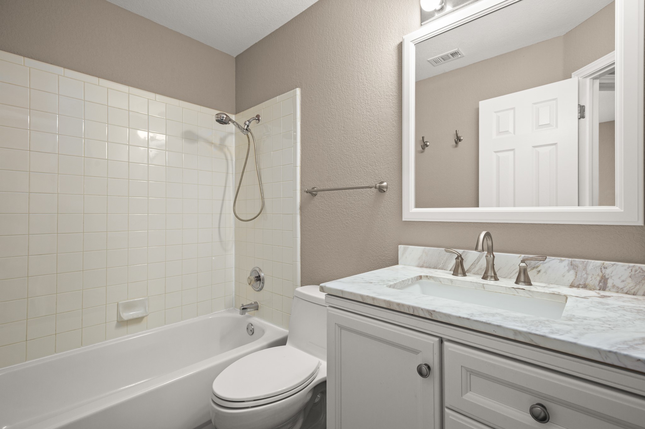 3420 Ribbon Reef Lane Austin, TX 78728 - Photo 19 of 25 Updated hall bath with new toilet, vanity, light, mirror