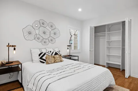 a bedroom with a bed and a window