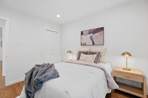 a bedroom with a bed and a potted plant