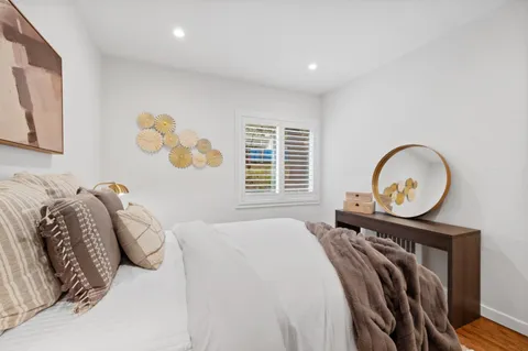 a bed sitting in a bedroom next to a window