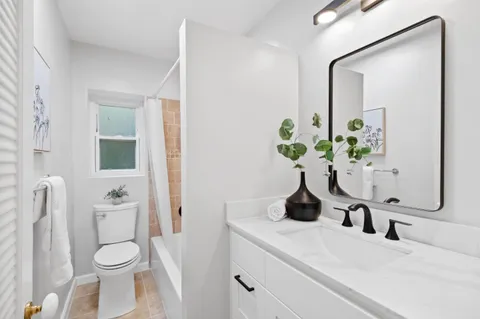 a bathroom with a toilet a sink and a mirror