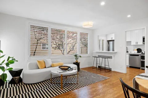 a living room with furniture and a rug