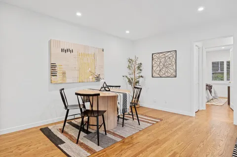 a view of a dining room with furniture and wooden floor