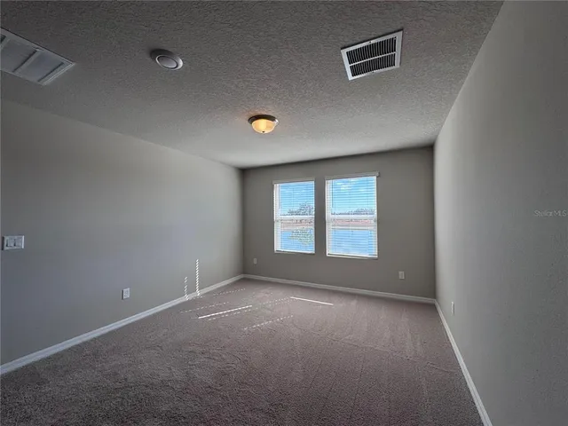 an empty room with a empty space and windows