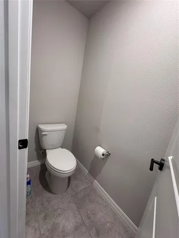 a white toilet sitting next to a shower