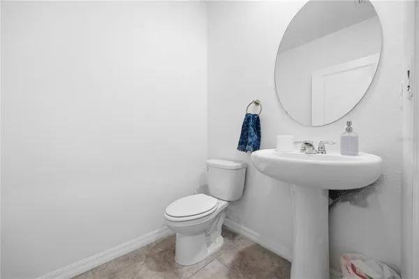 a bathroom with a sink toilet and a mirror