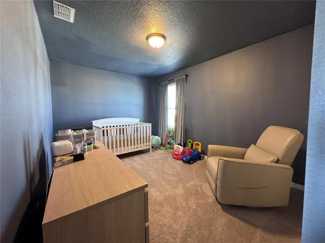 a hallway with a couch and chandelier