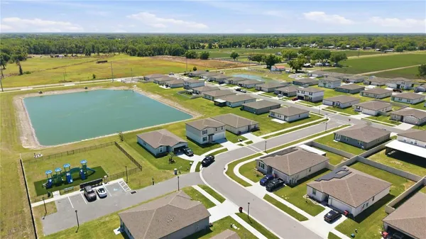 an aerial view of residential houses with outdoor space