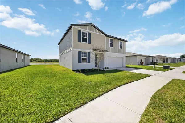 a front view of house with yard and green space