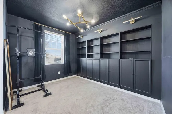 a view of an empty room with a cabinet