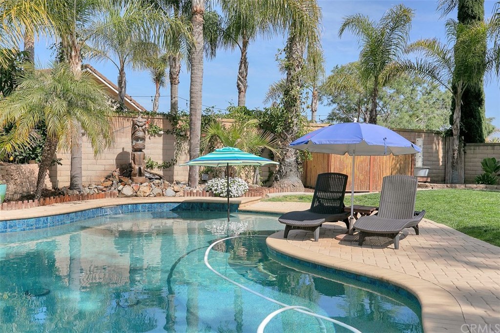 1306 Altura San Clemente, CA 92673 - Photo 23 of 28 This inviting saltwater pool with a fire head tiki and peaceful water falls is just waiting for you to jump on in!