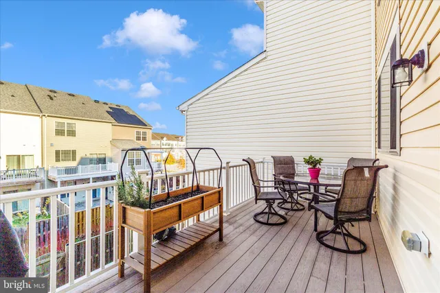 a view of balcony with wooden floor and outdoor seating