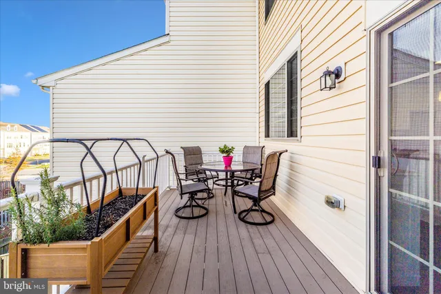 a view of balcony with chairs and wooden fence