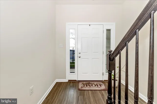 a view of an entryway with wooden floor