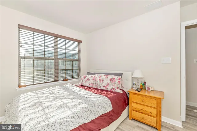 a bed sitting in a bedroom next to a window