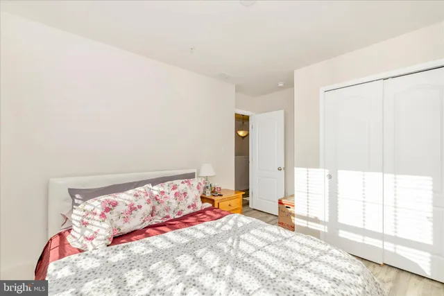 a bedroom with a bed and a large window